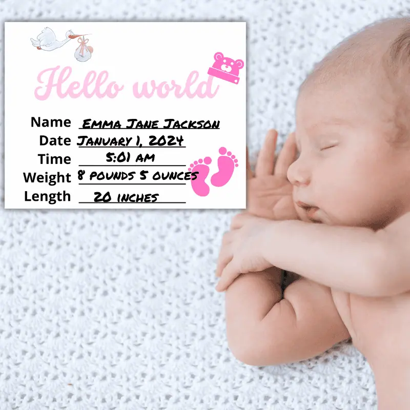 A baby milestone sign that says hello world and has a pink baby hat in the shape of a teddy bear hanging off of the d set next to a newborn in her crib. The sign features the baby's name, date and time of birth, weight and length.