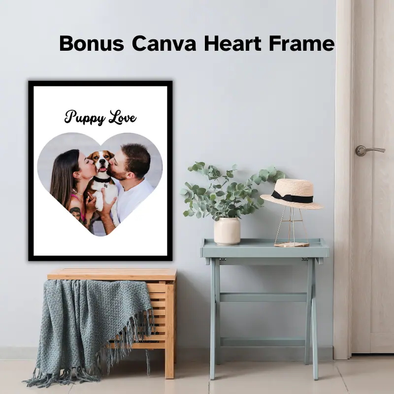 A framed photo in the shape of a heart hanging on a wall in a home entryway. It is a photo of a couple both kissing their dogs nose and the words Puppy Love at the top. Bonus Canva Heart Frame is written across the wall.