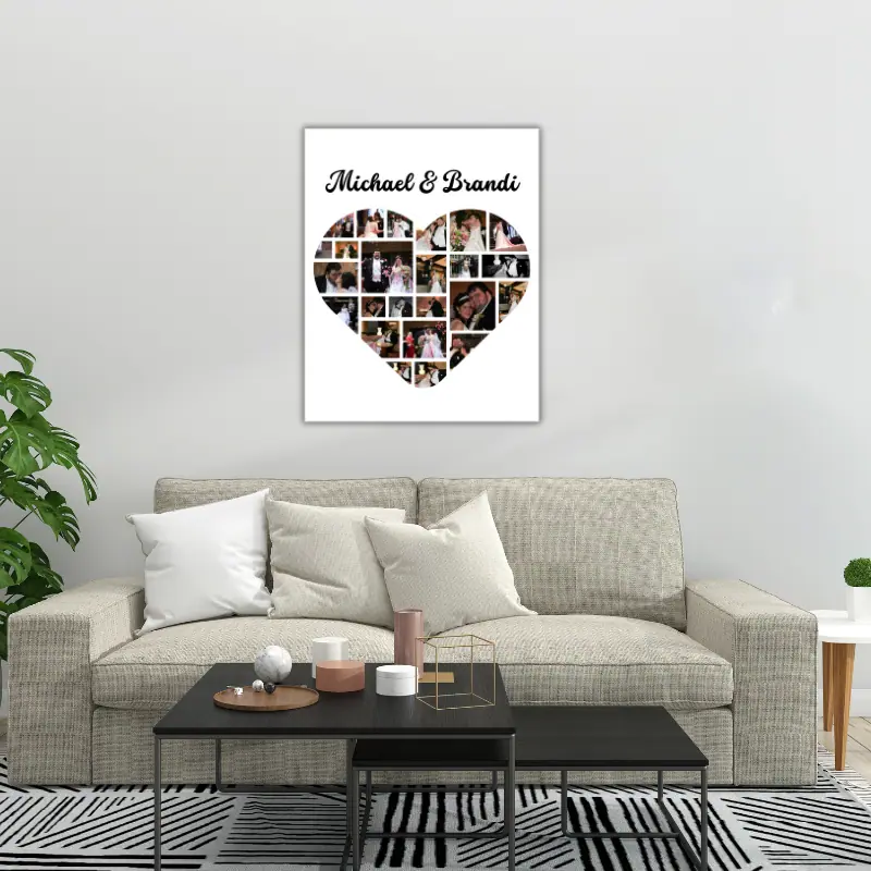 A large poster of a wedding photo collage, in the shape of a heart, hanging on the wall above a couch.