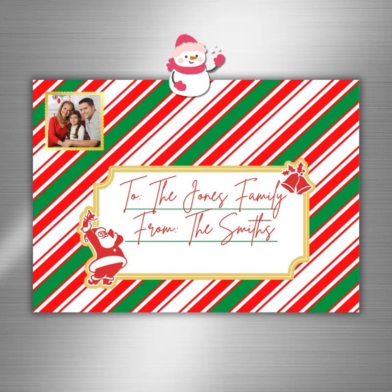 A Christmas photo card on a fridge designed as a letter with candy cane stripes. There is a label on the front to write a message and room for one photo shaped like a stamp in the left corner.