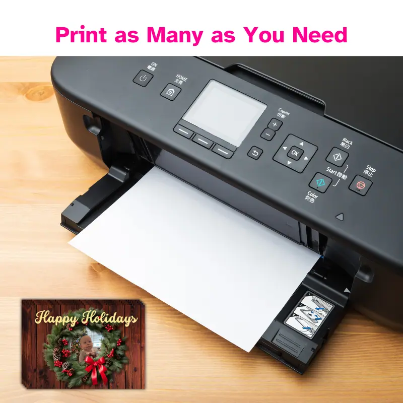 Print anywhere, as many as you need. A printer with a stack of Christmas cards printed next to it.