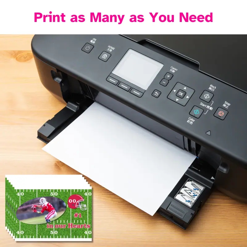 A printer with a stack of photo cards printed beside it. The cards are all the same football photo card.