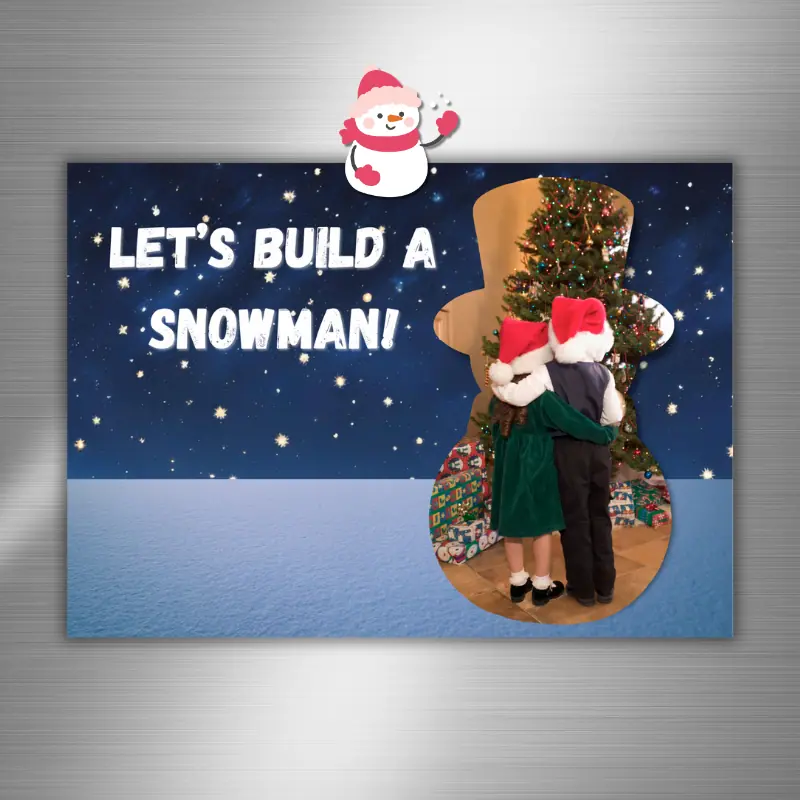 a photo card in on the fridge with a photo in the shape of a snowman in front of a winter night and the words, let's build a snowman.
