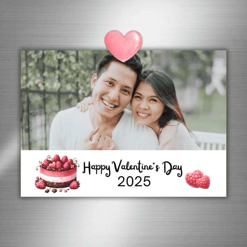 A photo card that says Happy Valentine's Day with the year, a raspberry layer cake, and a landscape photo of a happy couple hanging on a fridge with a pink heart magnet